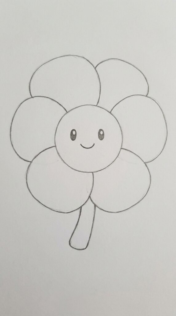  Simple pencil cartoon drawing of a pansy flower with a smiling face, large round petals, and a short chunky stem on white paper.