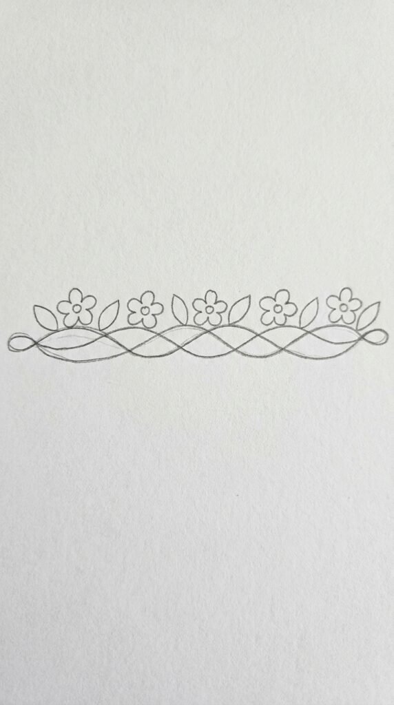  Pencil drawing of a circular mogra flower wreath with eight jasmine blooms and small leaves arranged in a ring on white paper.