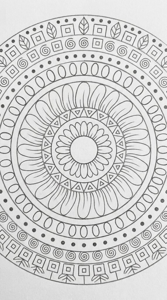 Pencil sketch of a circular sunflower mandala with concentric rings of petals and geometric shapes on white paper.