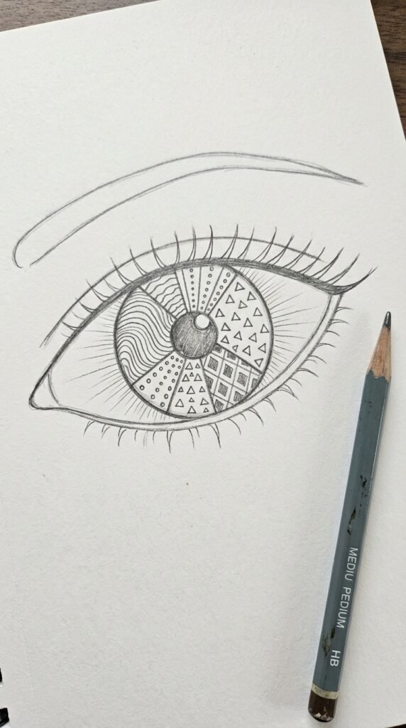 Trippy Zentangle eye drawing for kids filled with easy doodle patterns inside the iris on white paper.